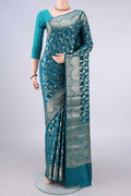Pure Silk Teal Banarasi Raw Saree with Zari Butta on the body and Zari Border.  displayed on a mannequin