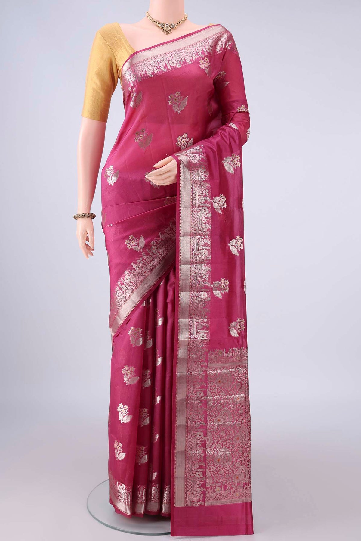 Pure Silk Dark Pink Banarasi Raw Saree with Zari Butta on the body and Zari Border.  displayed on a mannequin