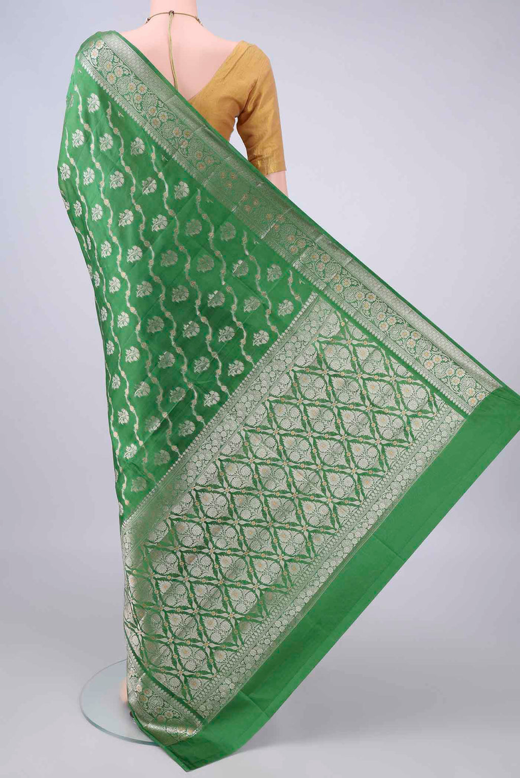 Flat view of Pure Silk Green Banarasi Raw Saree with Zari Butta on the body and Zari Border. 