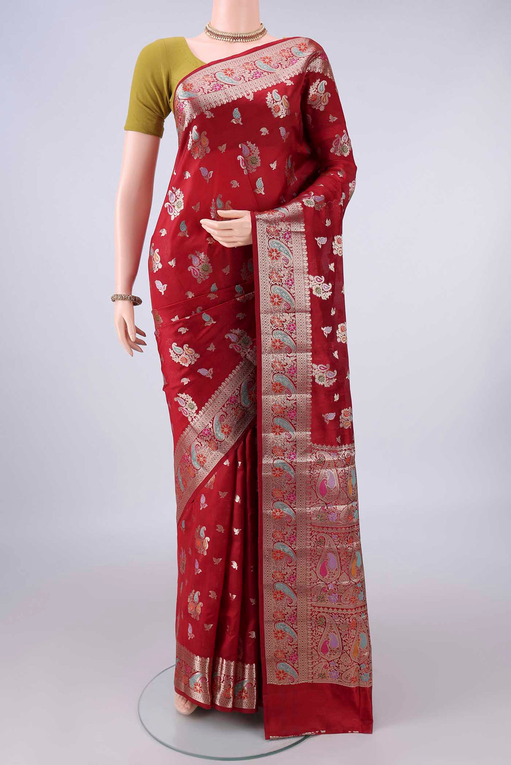 Pure Silk Imperial Red Banarasi Raw Saree with Zari And Thread Butta on the body and Zari And Thread Border.  displayed on a mannequin