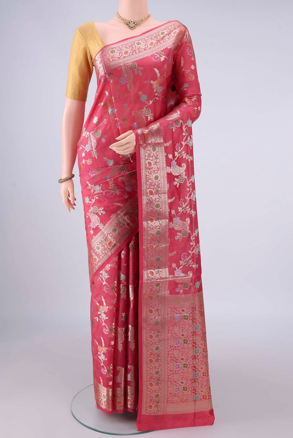 Pure Silk Coral Banarasi Raw Saree with Zari And Thread Butta on the body and Zari And Thread Border.  displayed on a mannequin
