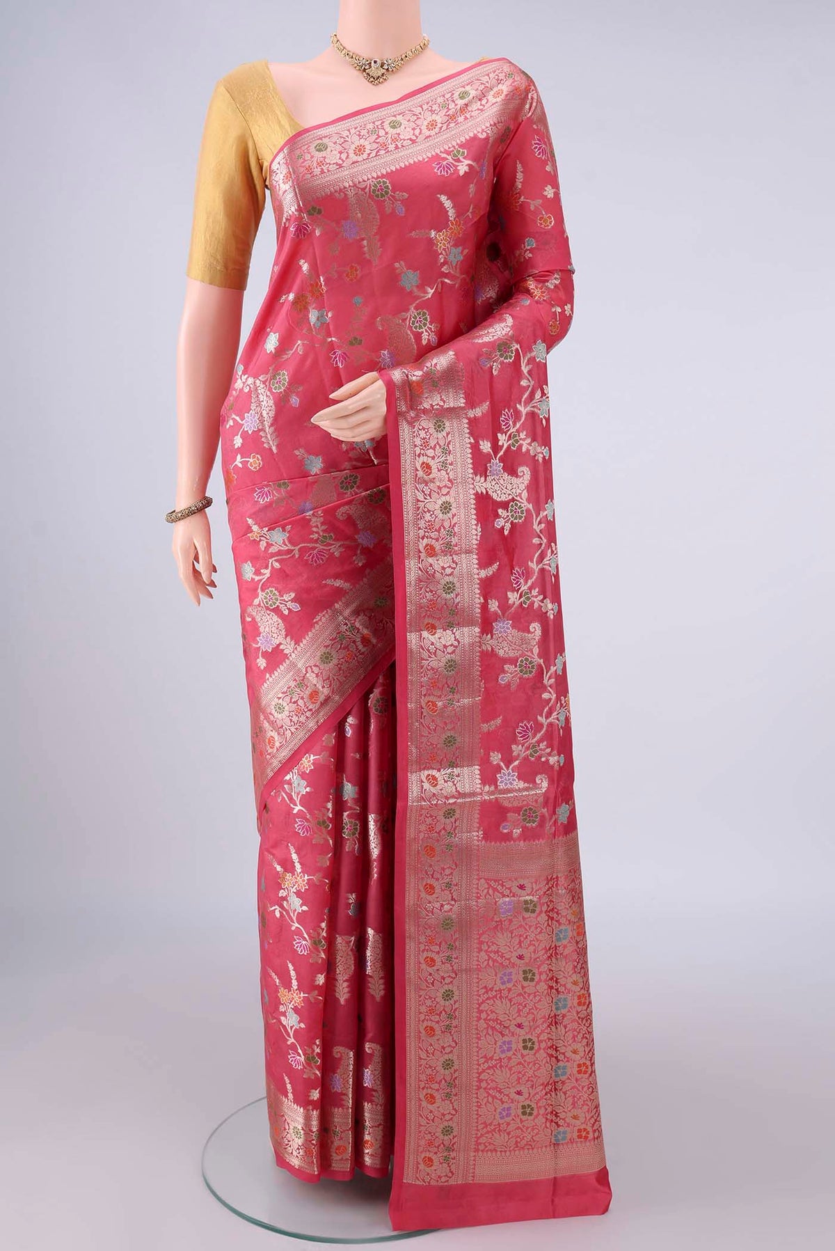 Pure Silk Coral Banarasi Raw Saree with Zari And Thread Butta on the body and Zari And Thread Border.  displayed on a mannequin