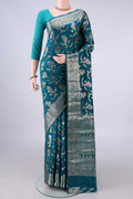 Pure Silk Teal Banarasi Raw Saree with Zari And Thread Butta on the body and Zari And Thread Border.  displayed on a mannequin