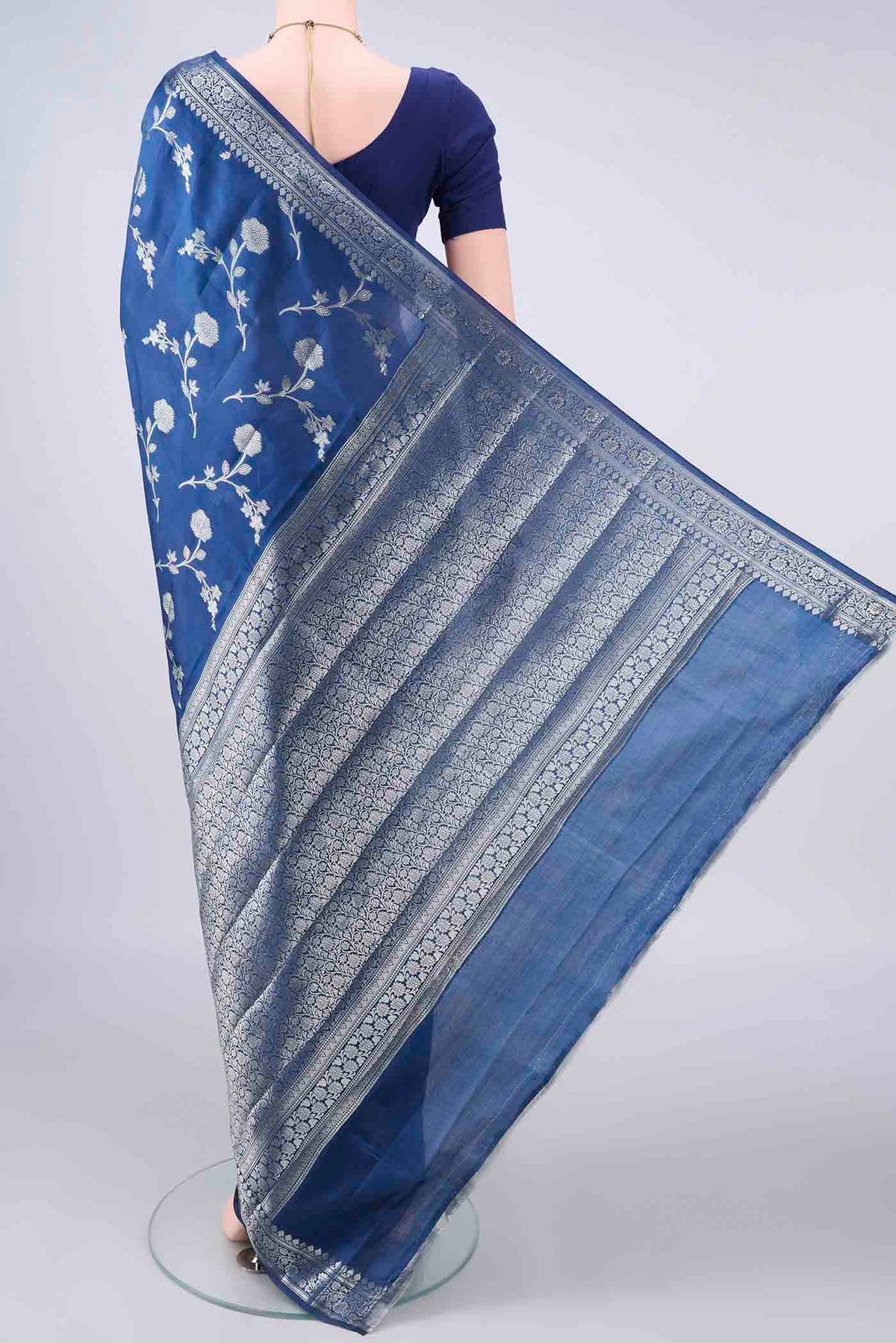 Flat view of Pure Silk Blue Banarasi Raw Saree with Zari Butta on the body and Zari Border. 