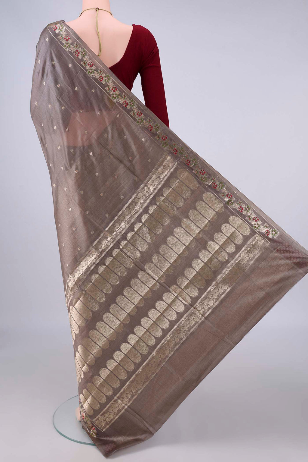 Flat view of Davys Grey Banarasi Tussar Saree with Zari And Thread Butta on the body and Zari And Thread Border. 