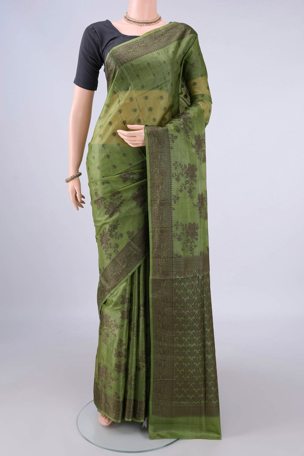 Light Green Banarasi Tussar Saree with Thread Butta on the body and Thread Border.  displayed on a mannequin