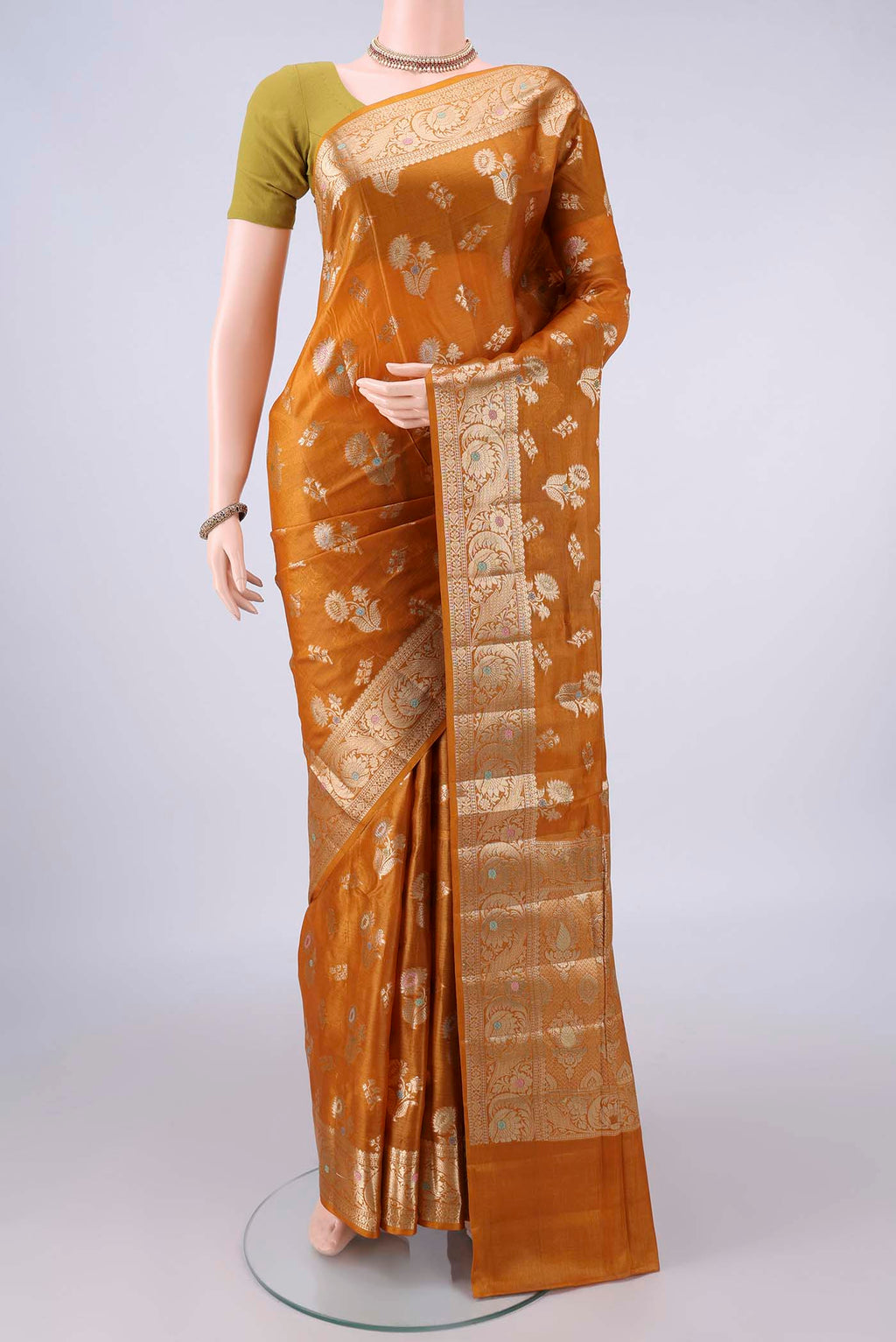 Mustard Banarasi Tussar Saree with Zari And Thread Butta on the body and Zari And Thread Border.  displayed on a mannequin