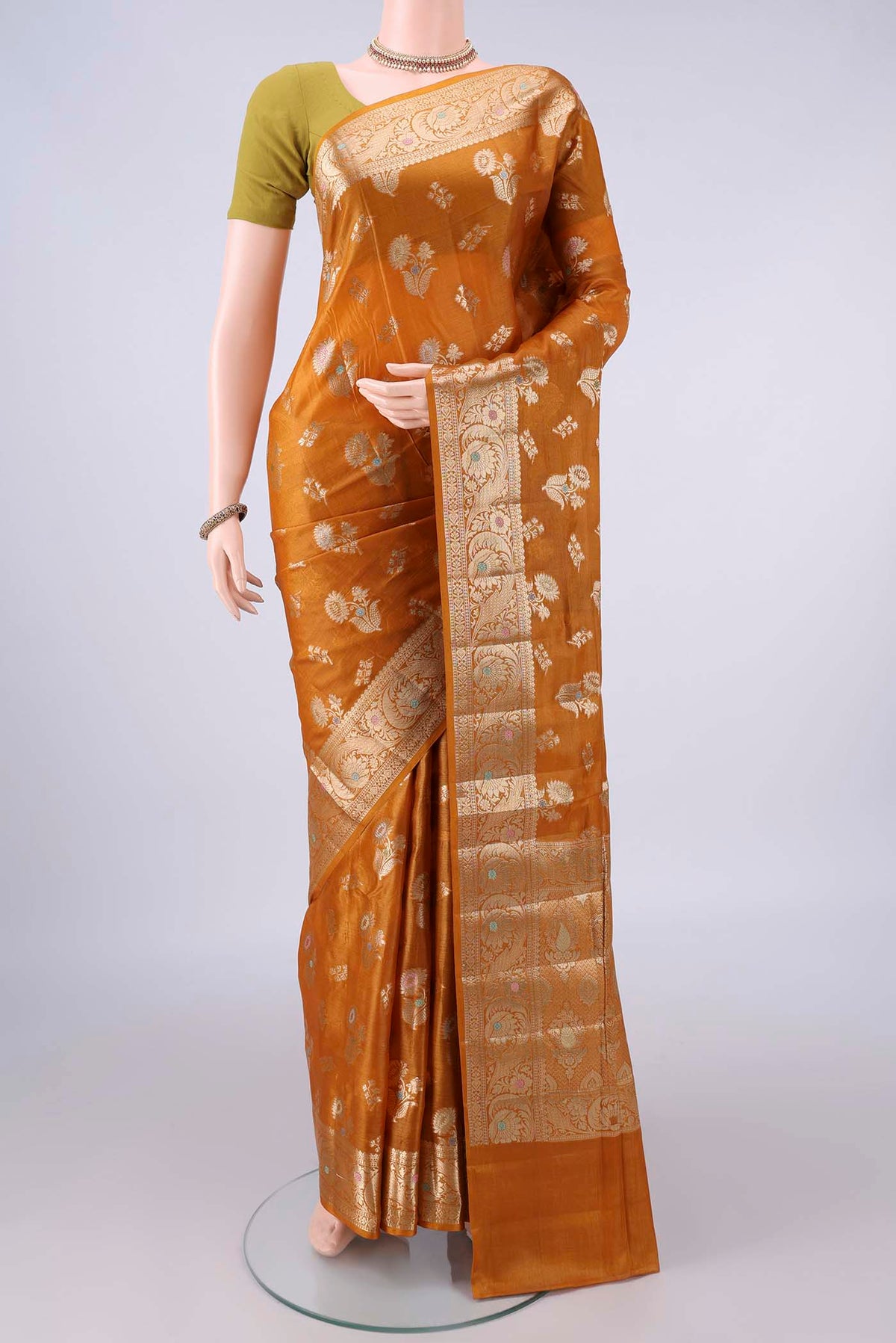Mustard Banarasi Tussar Saree with Zari And Thread Butta on the body and Zari And Thread Border.  displayed on a mannequin