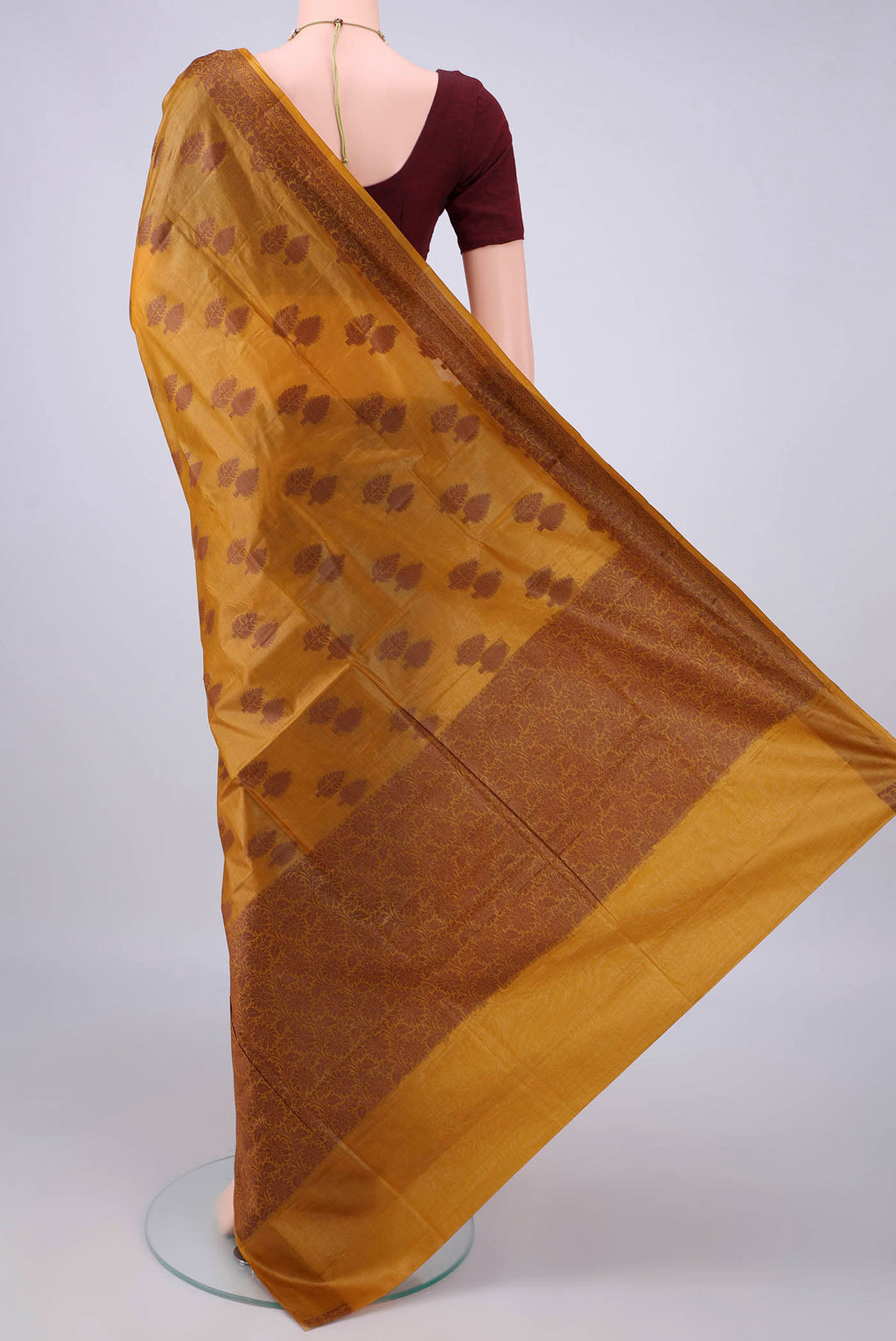 Flat view of Mustard Banarasi Tussar Saree with Thread Butta on the body and Thread Border. 