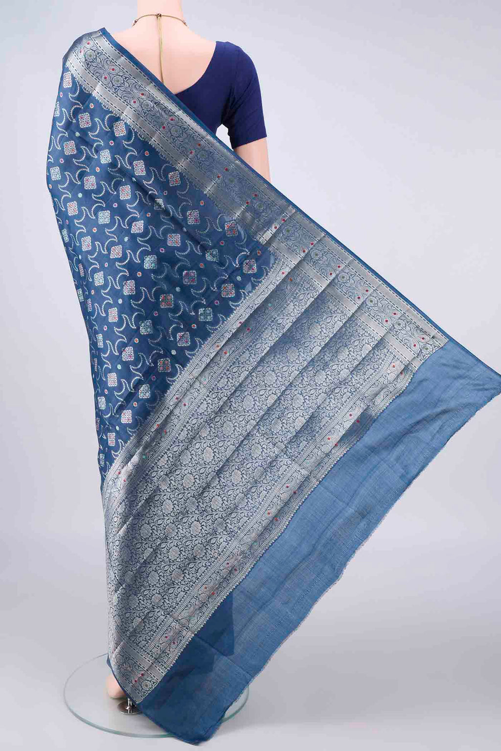 Flat view of Blue Banarasi Tussar Saree with Zari Brocade on the body and Zari And Thread Border. 