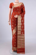 Rust Banarasi Tussar Saree with Zari And Thread Butta on the body and Zari And Thread Border.  displayed on a mannequin