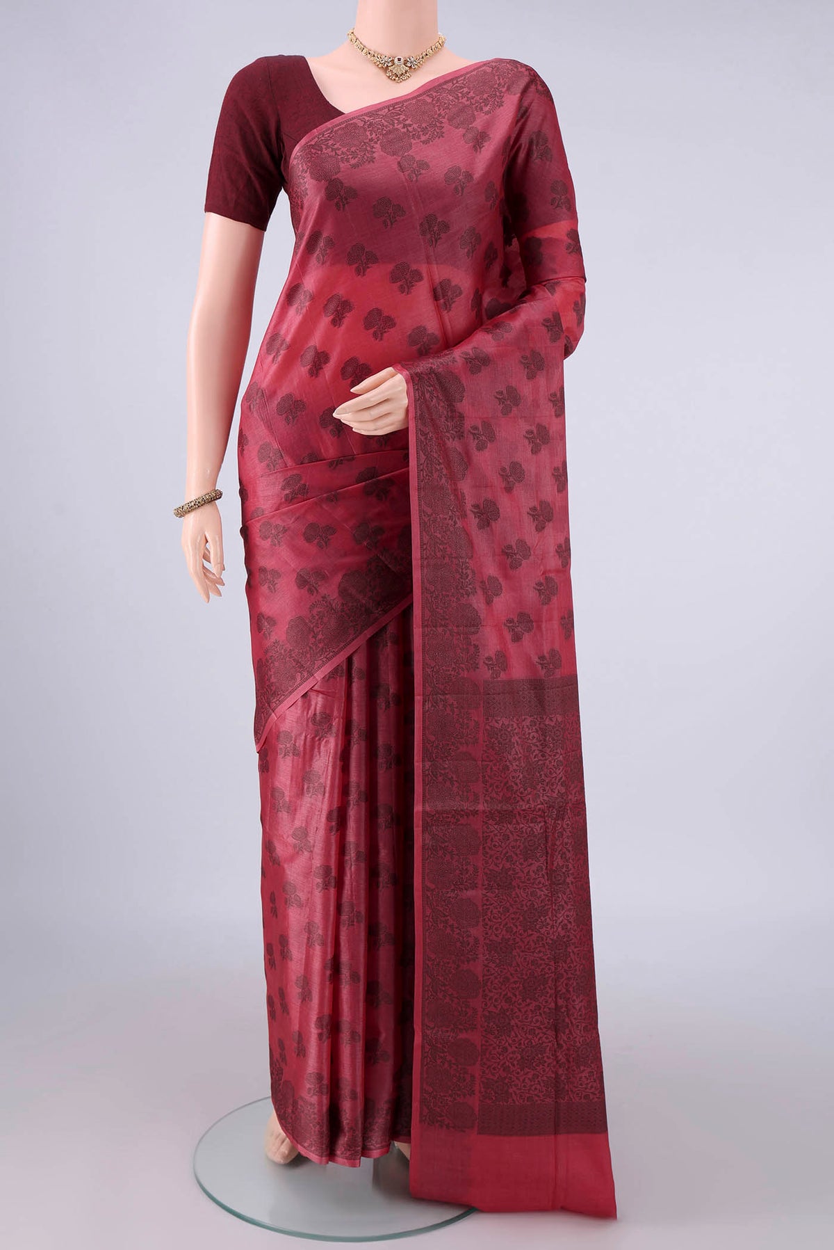 Peach Banarasi Tussar Saree with Thread Butta on the body and Thread Border.  displayed on a mannequin