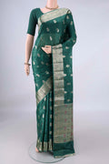 Bottle Green Banarasi Tussar Saree with Zari And Thread Butta on the body and Zari And Thread Border.  displayed on a mannequin