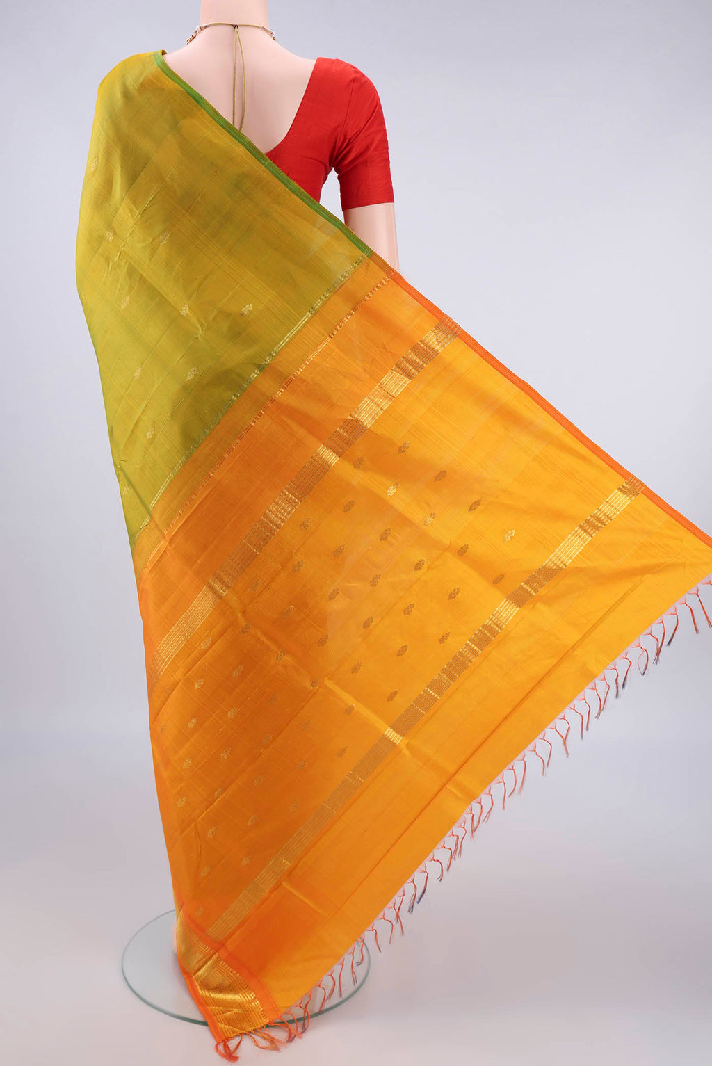 Flat view of Pure Silk Acid Green Kanjivaram Saree with Zari Butta on the body and One Side Border. 