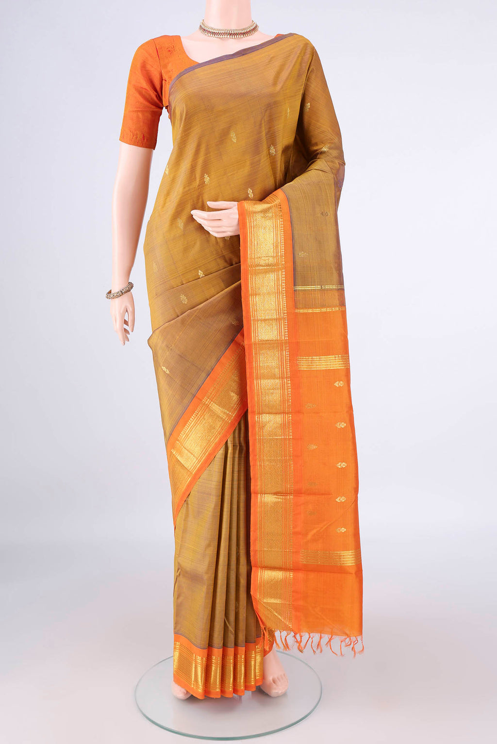 Pure Silk Golden Kanjivaram Saree with Zari Butta on the body and Zari Border.  displayed on a mannequin