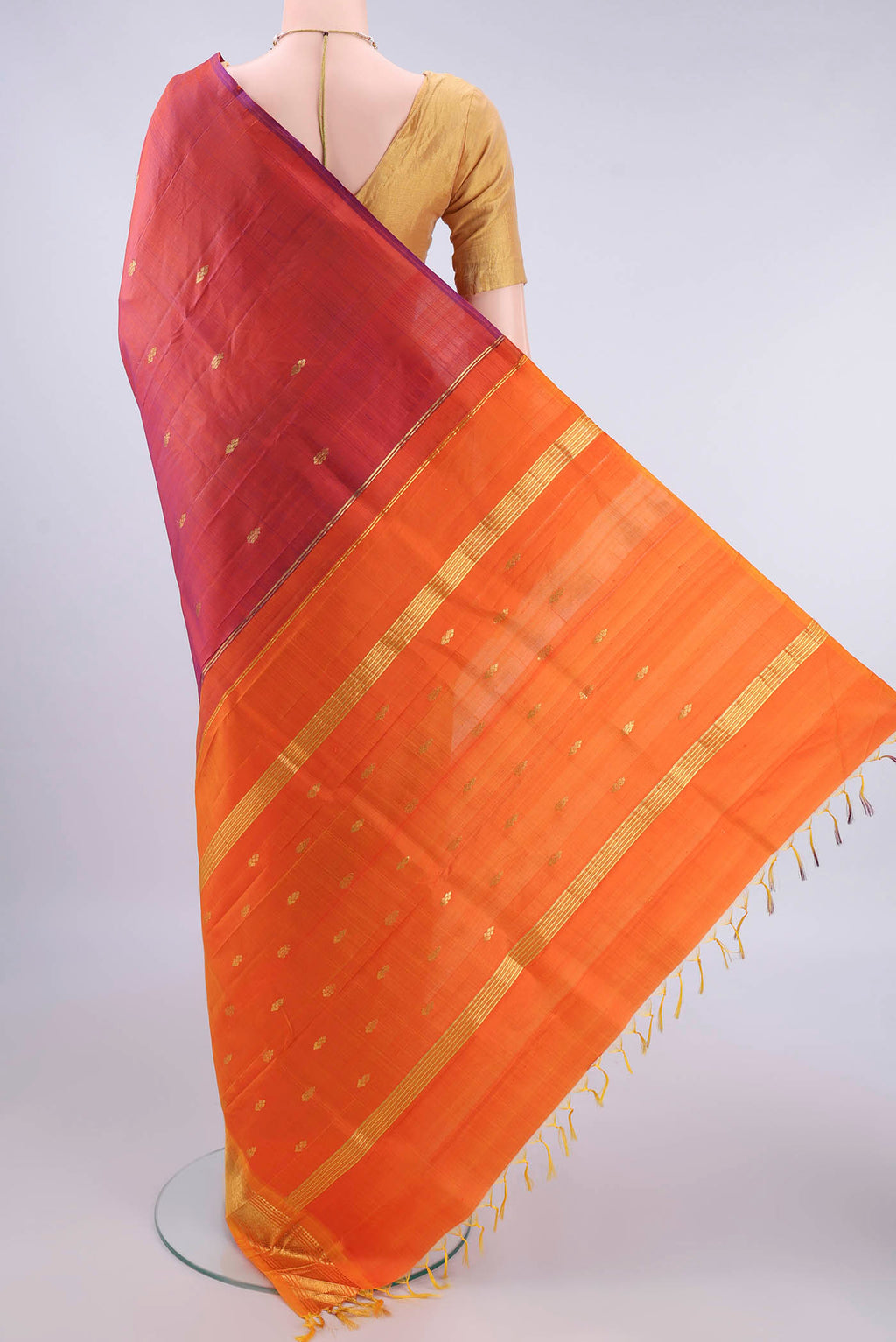 Flat view of Pure Silk Rust Kanjivaram Saree with Zari Butta on the body and One Side Border. 
