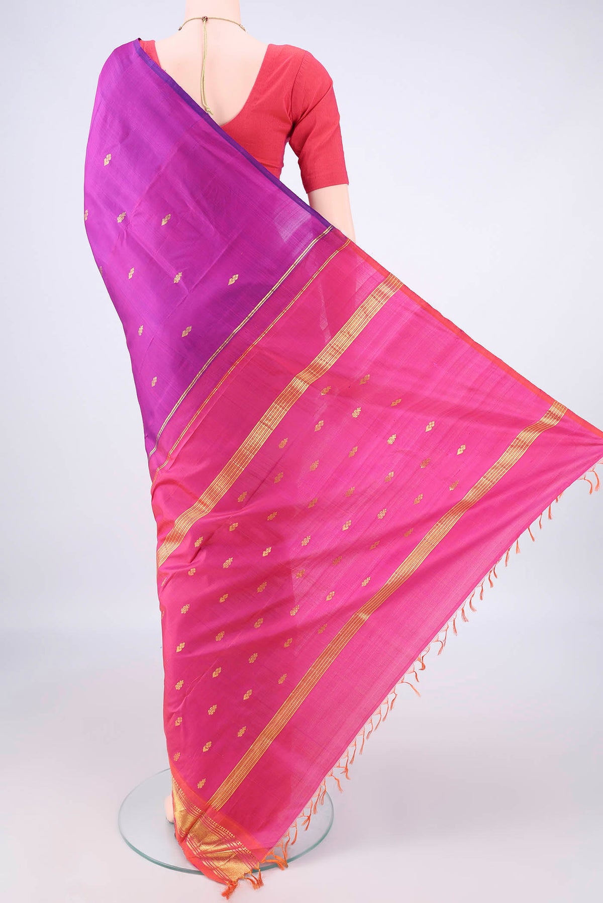 Flat view of Pure Silk Magenta Kanjivaram Saree with Zari Butta on the body and Zari Border. 