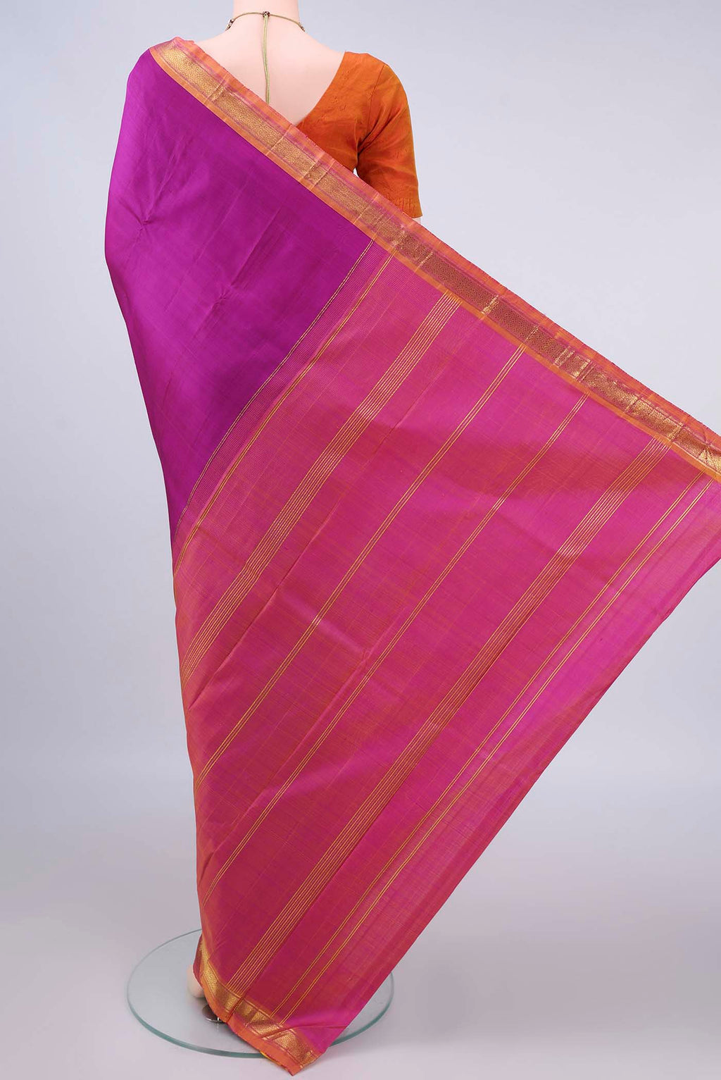 Flat view of Pure Silk Magenta Kanjivaram Saree with Plain Body and Zari Border. 