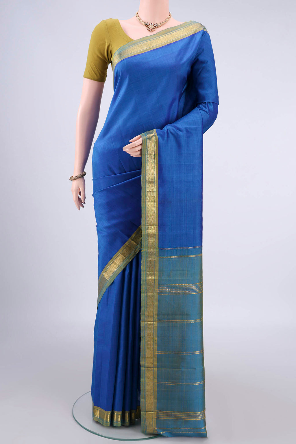 Pure Silk Blue Kanjivaram Saree with Plain Body and Zari Border.  displayed on a mannequin