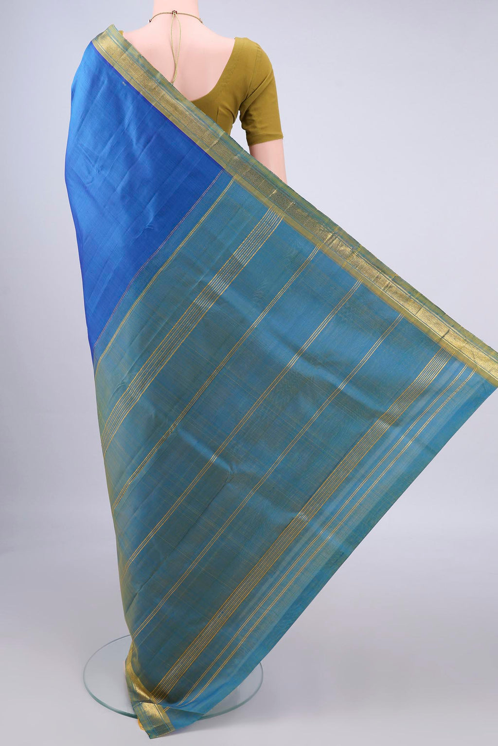 Flat view of Pure Silk Blue Kanjivaram Saree with Plain Body and Zari Border. 