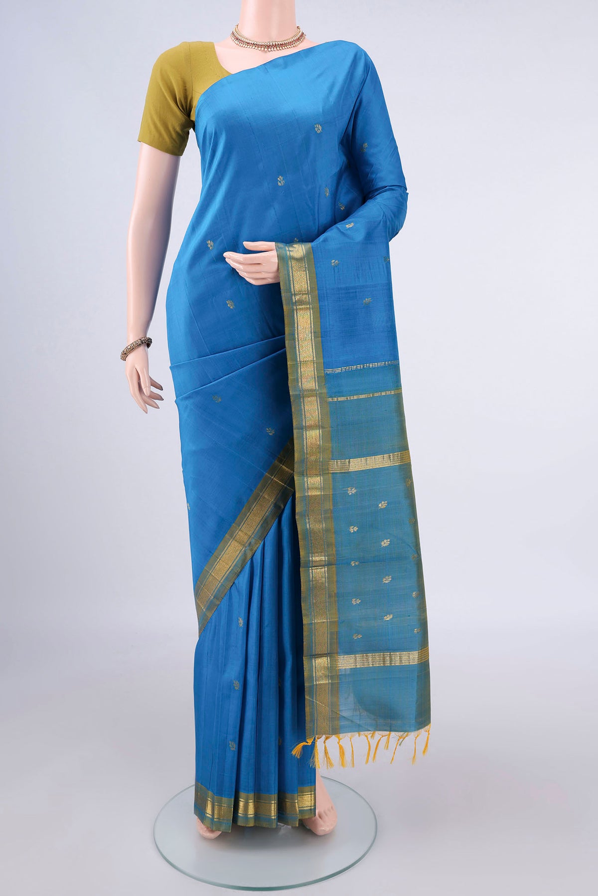 Pure Silk Blue Kanchipuram Saree with Zari Butta on the body and One Side Border.  displayed on a mannequin