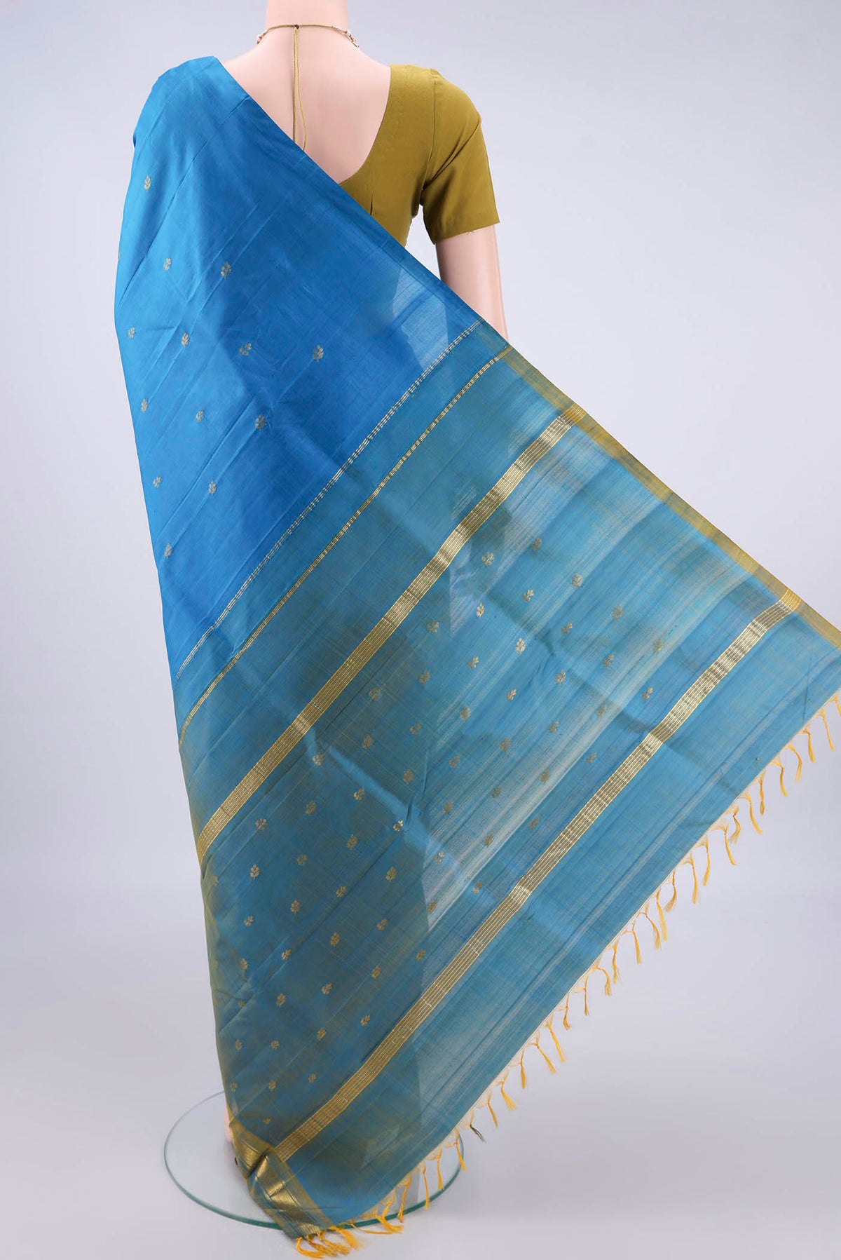 Flat view of Pure Silk Blue Kanchipuram Saree with Zari Butta on the body and One Side Border. 