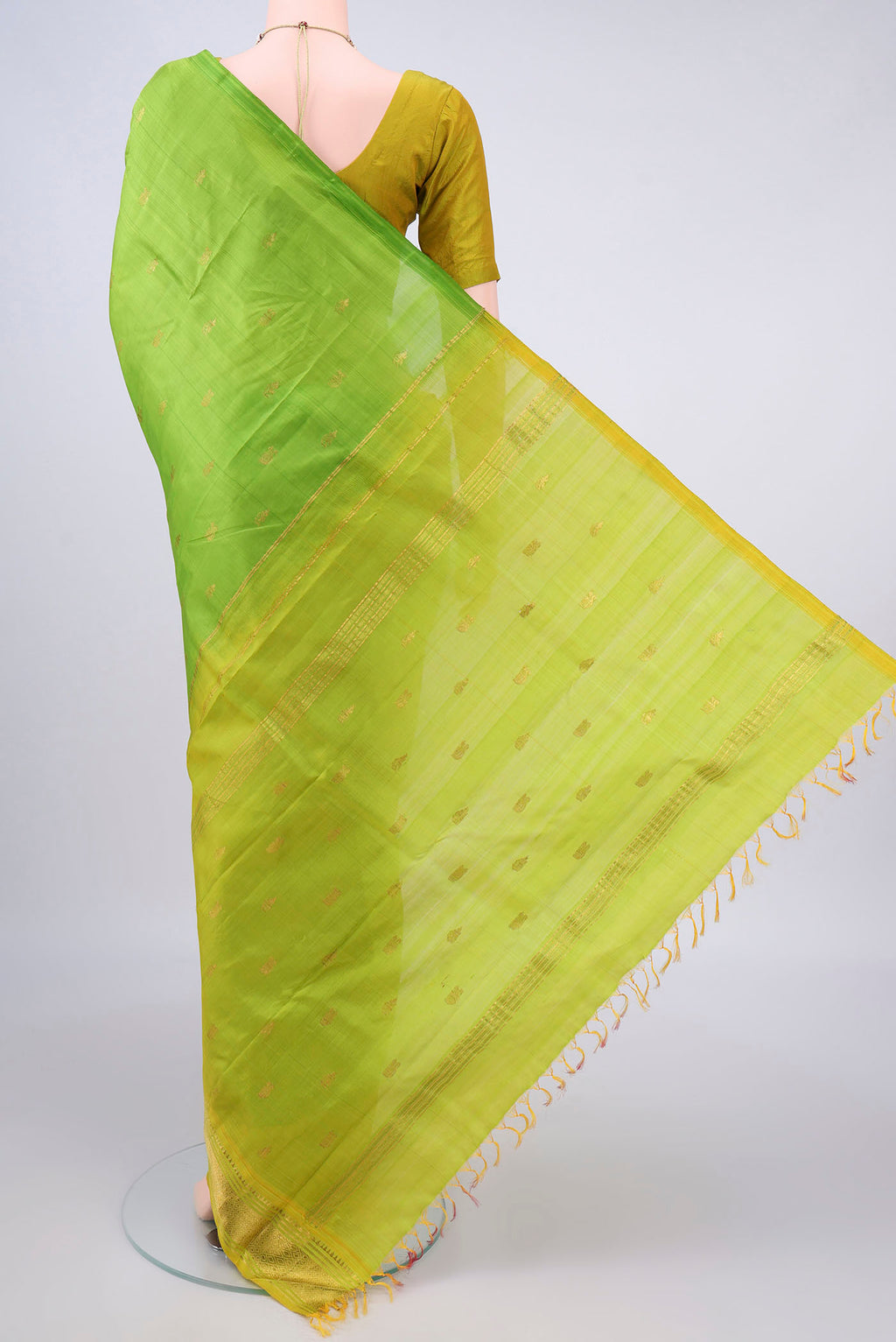Flat view of Pure Silk Parrot Green Kanjivaram Saree with Zari Butta on the body and One Side Border. 