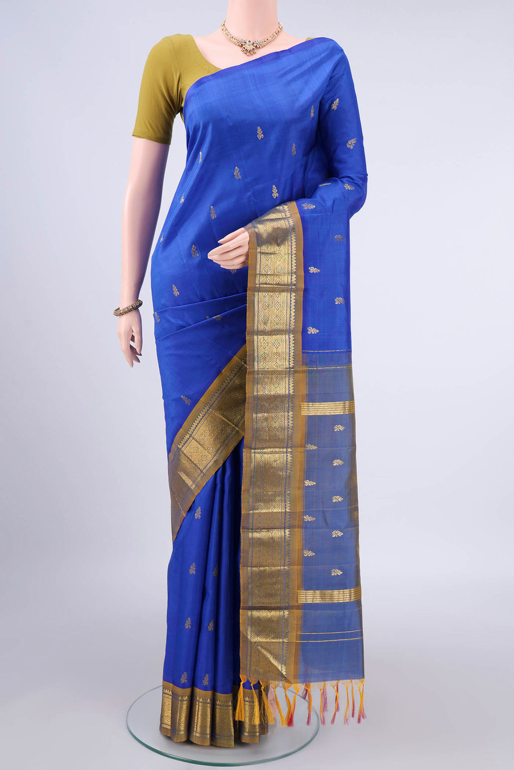 Pure Silk Blue Kanjivaram Saree with Zari Butta on the body and One Side Border.  displayed on a mannequin