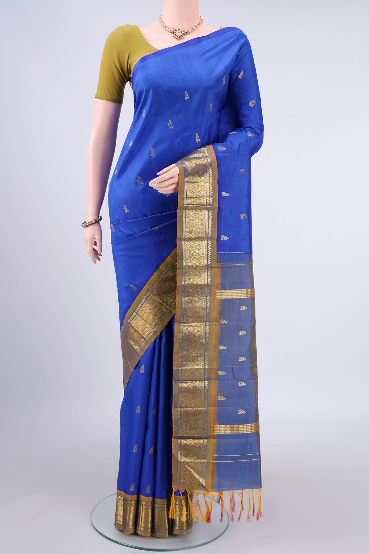 Pure Silk Blue Kanjivaram Saree with Zari Butta on the body and One Side Border.  displayed on a mannequin