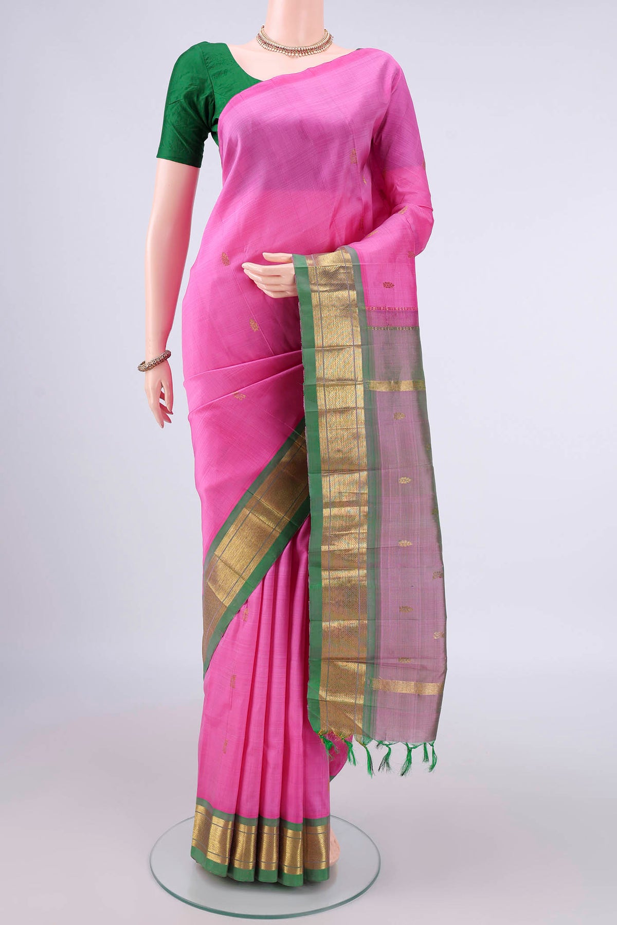 Pure Silk Pink Kanjivaram Saree with Zari Butta on the body and One Side Border.  displayed on a mannequin