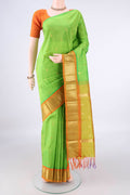 Pure Silk Parrot Green Kanjivaram Saree with Zari Butta on the body and One Side Border.  displayed on a mannequin