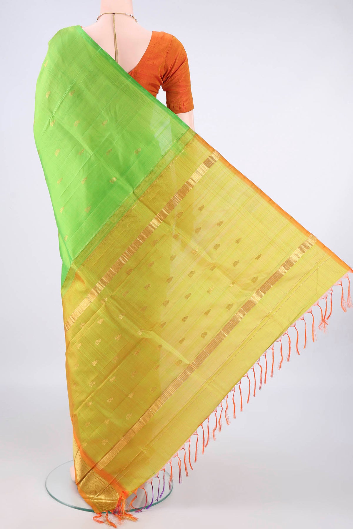Flat view of Pure Silk Parrot Green Kanjivaram Saree with Zari Butta on the body and One Side Border. 