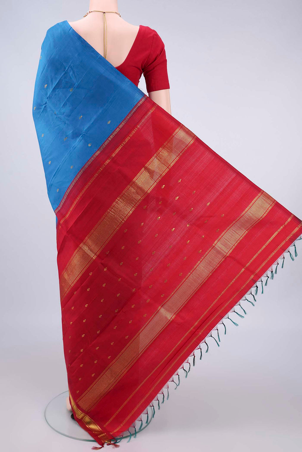 Flat view of Pure Silk Blue Kanjivaram Saree with Zari Butta on the body and One Side Border. 