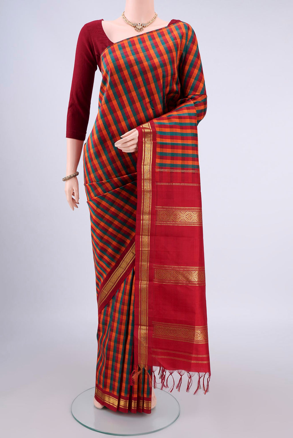 Pure Silk Multi Color Kanchipuram Saree with Checked design on the body and One Side Border.  displayed on a mannequin