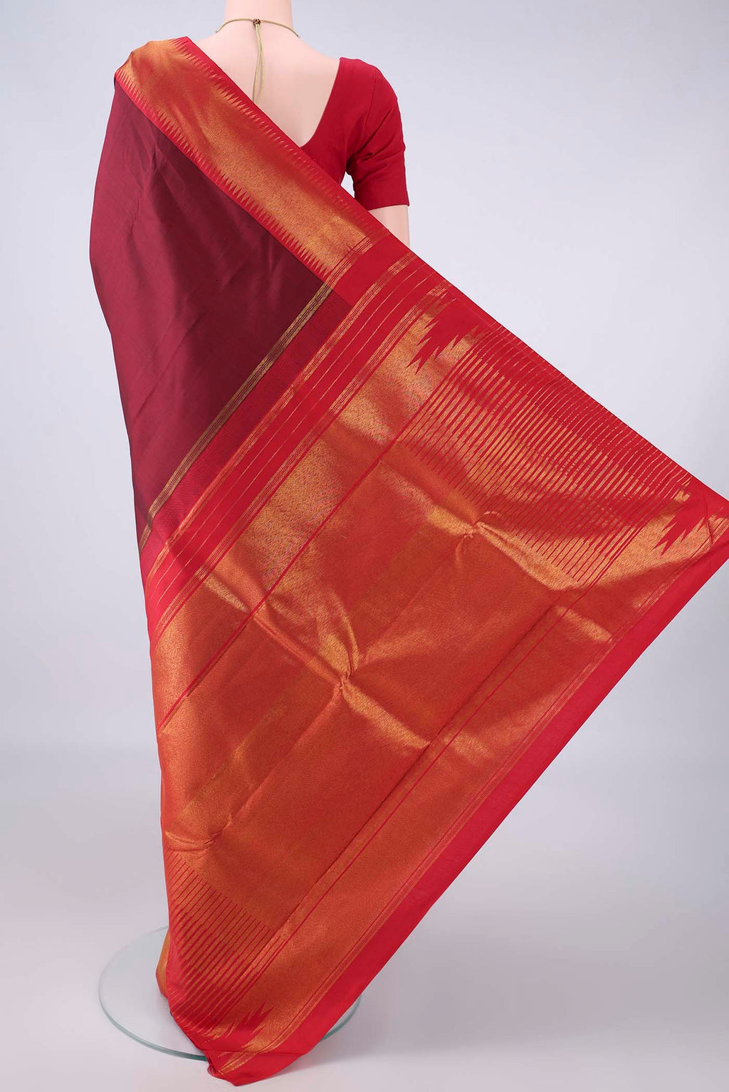 Flat view of Pure Silk Maroon Kanjivaram Saree with Plain Body and Temple Border. 