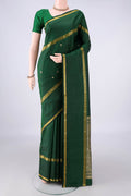 Pure Silk Bottle Green Kanjivaram Saree with Thread Butta on the body and Thread Border.  displayed on a mannequin