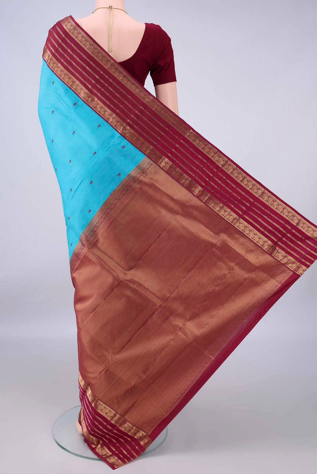 Flat view of Pure Silk Sky Blue Kanjivaram Saree with Thread Butta on the body and Zari Border. 