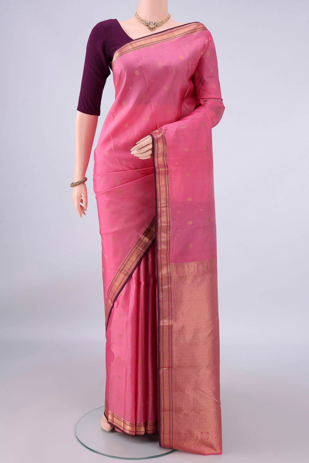 Pure Silk Rose pink Kanchipuram Saree with Zari Butta on the body and Zari Border.  displayed on a mannequin