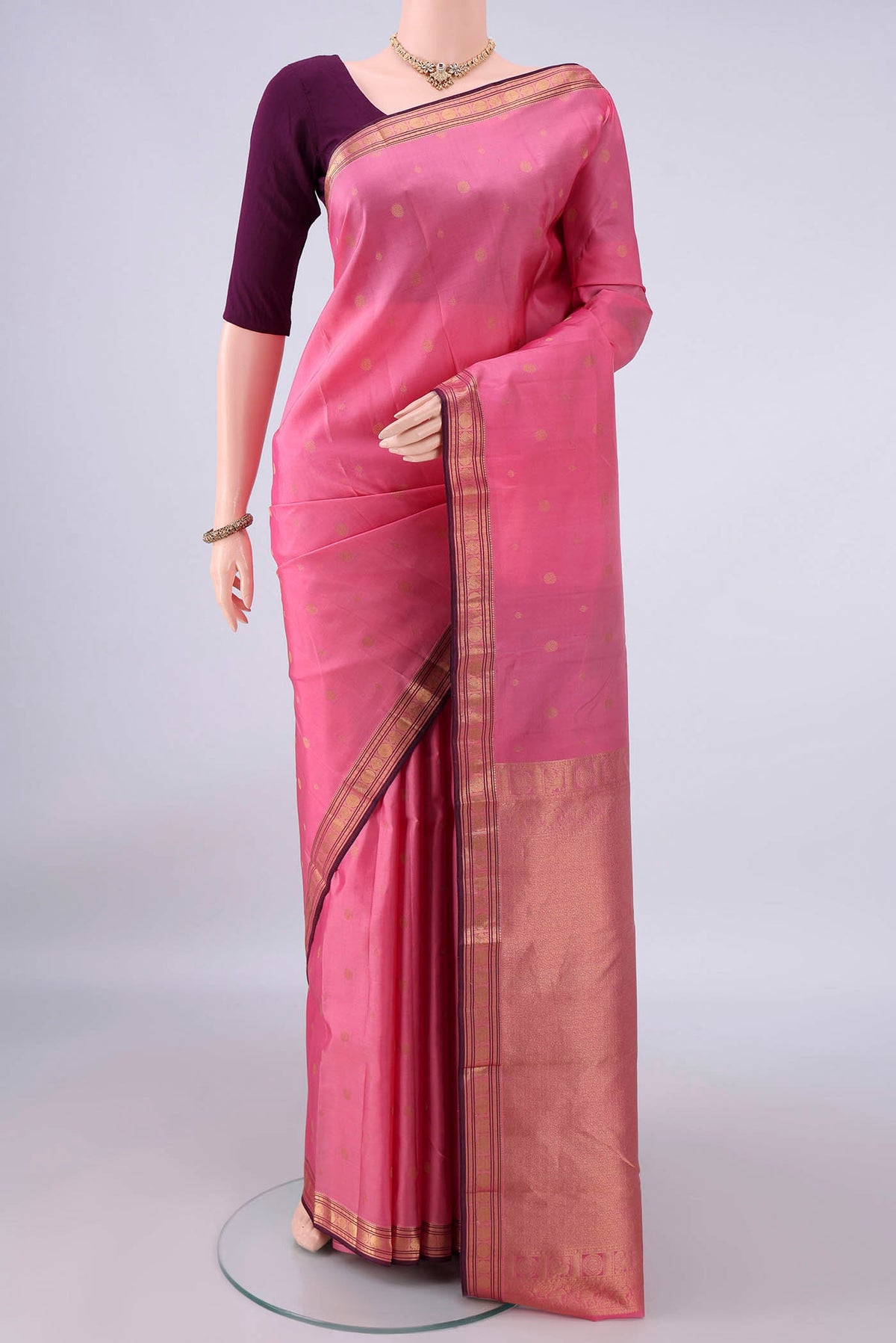 Pure Silk Rose pink Kanchipuram Saree with Zari Butta on the body and Zari Border.  displayed on a mannequin