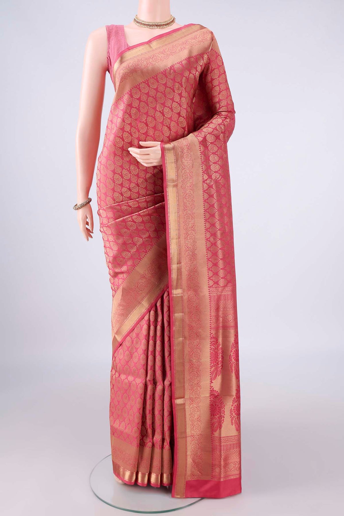 Pure Silk Coral Soft Saree with Zari Brocade on the body and Zari Border.  displayed on a mannequin