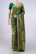 Pure Silk Bottle Green Soft Saree with Zari Brocade on the body and Zari Border.  displayed on a mannequin