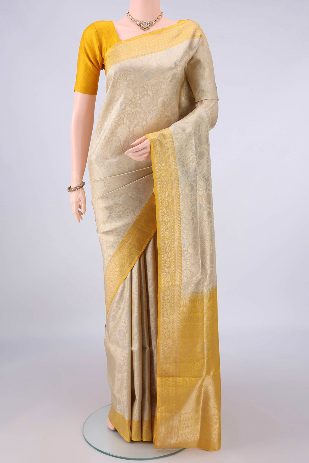 Pure Silk Dark Beige Soft Saree with Zari Brocade on the body and Zari Border.  displayed on a mannequin
