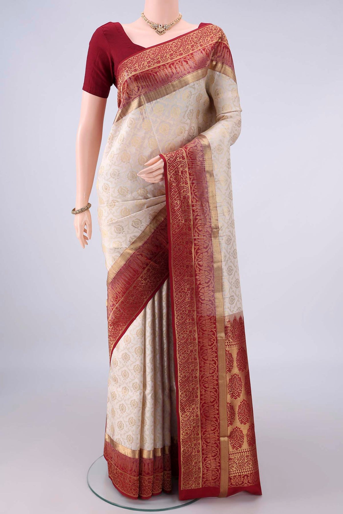 Pure Silk White Soft Saree with Zari Brocade on the body and Zari Border.  displayed on a mannequin