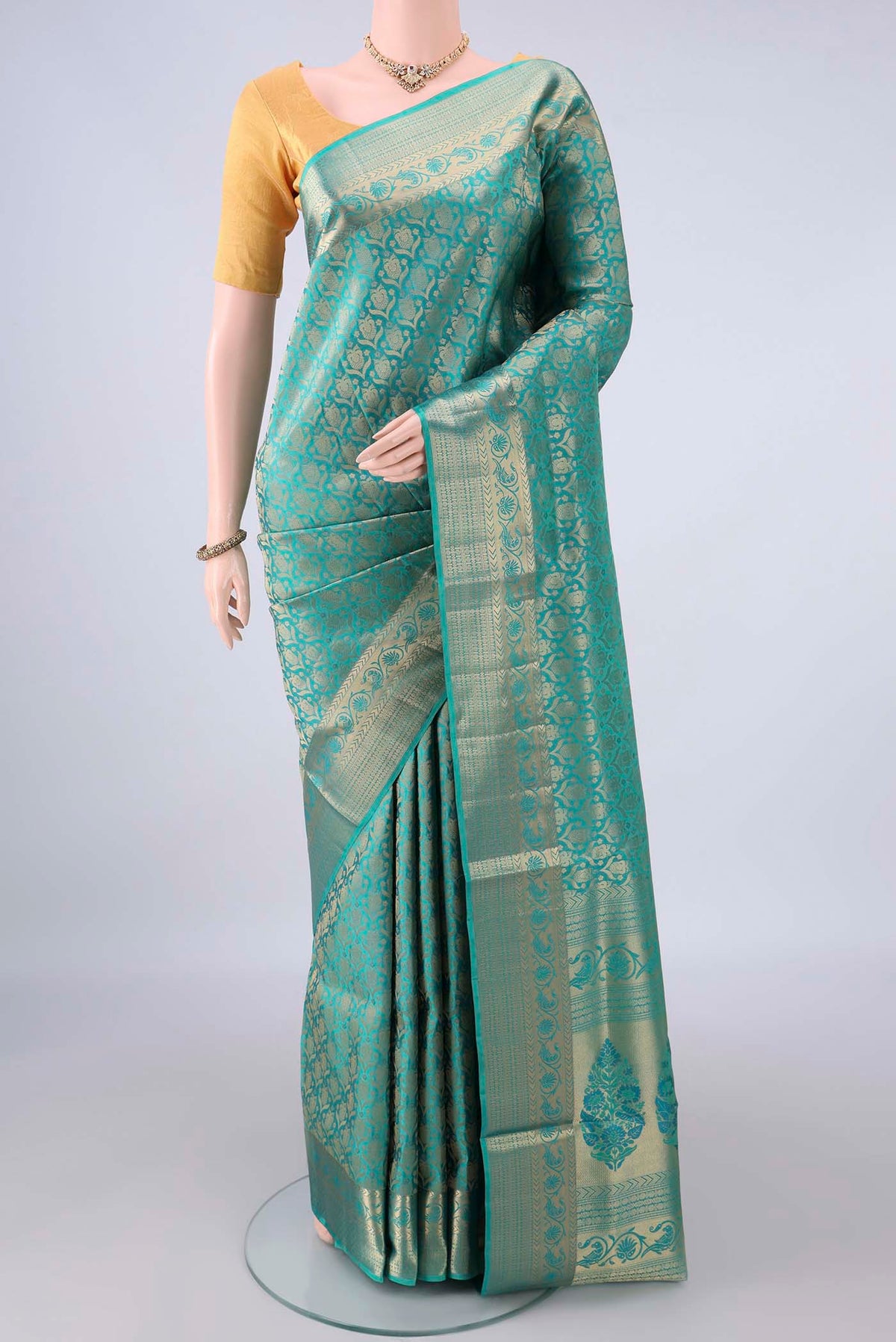 Pure Silk Turquoise Soft Saree with Zari Brocade on the body and Zari Border.  displayed on a mannequin