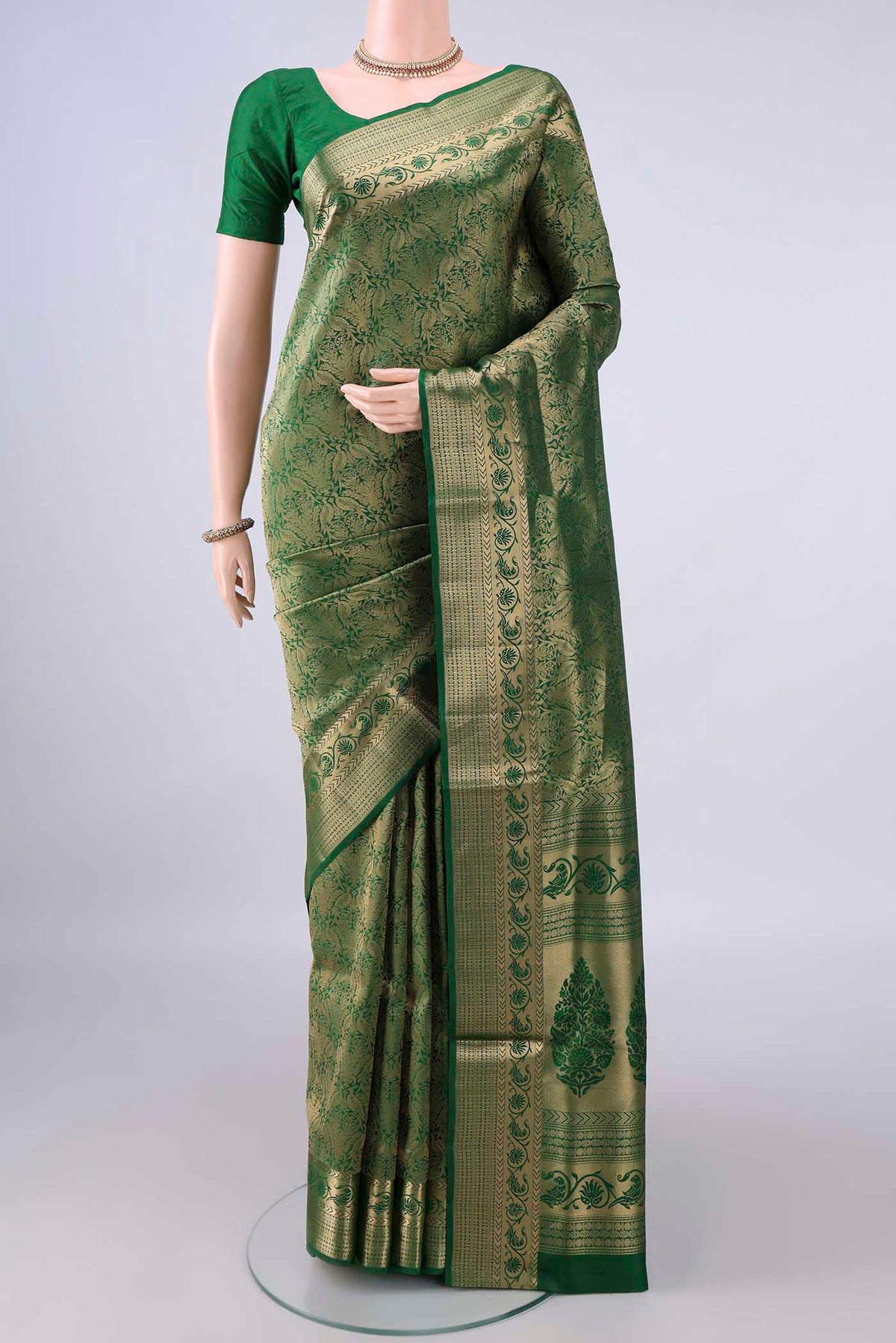 Pure Silk Bottle Green Soft Saree with Zari Brocade on the body and Zari Border.  displayed on a mannequin