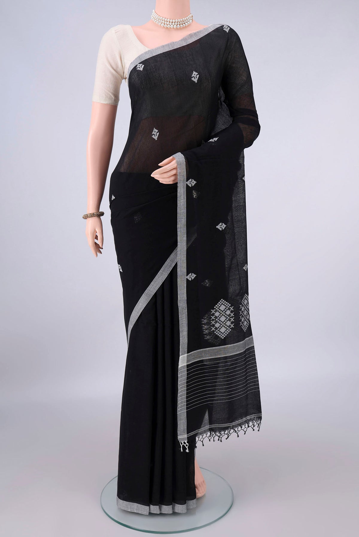 Black Bengal Cotton Saree with Thread Butta on the body and Plain Border.  displayed on a mannequin