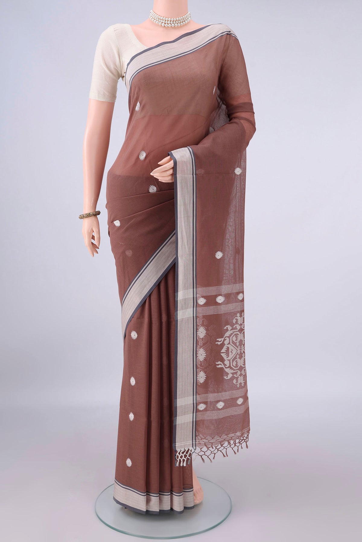 Brown Bengal Cotton Saree with Thread Butta on the body and Plain Border.  displayed on a mannequin