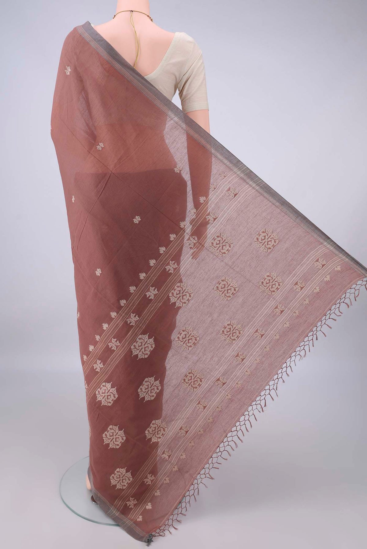 Flat view of Brown Bengal Cotton Saree with Thread Butta on the body and Plain Border. 