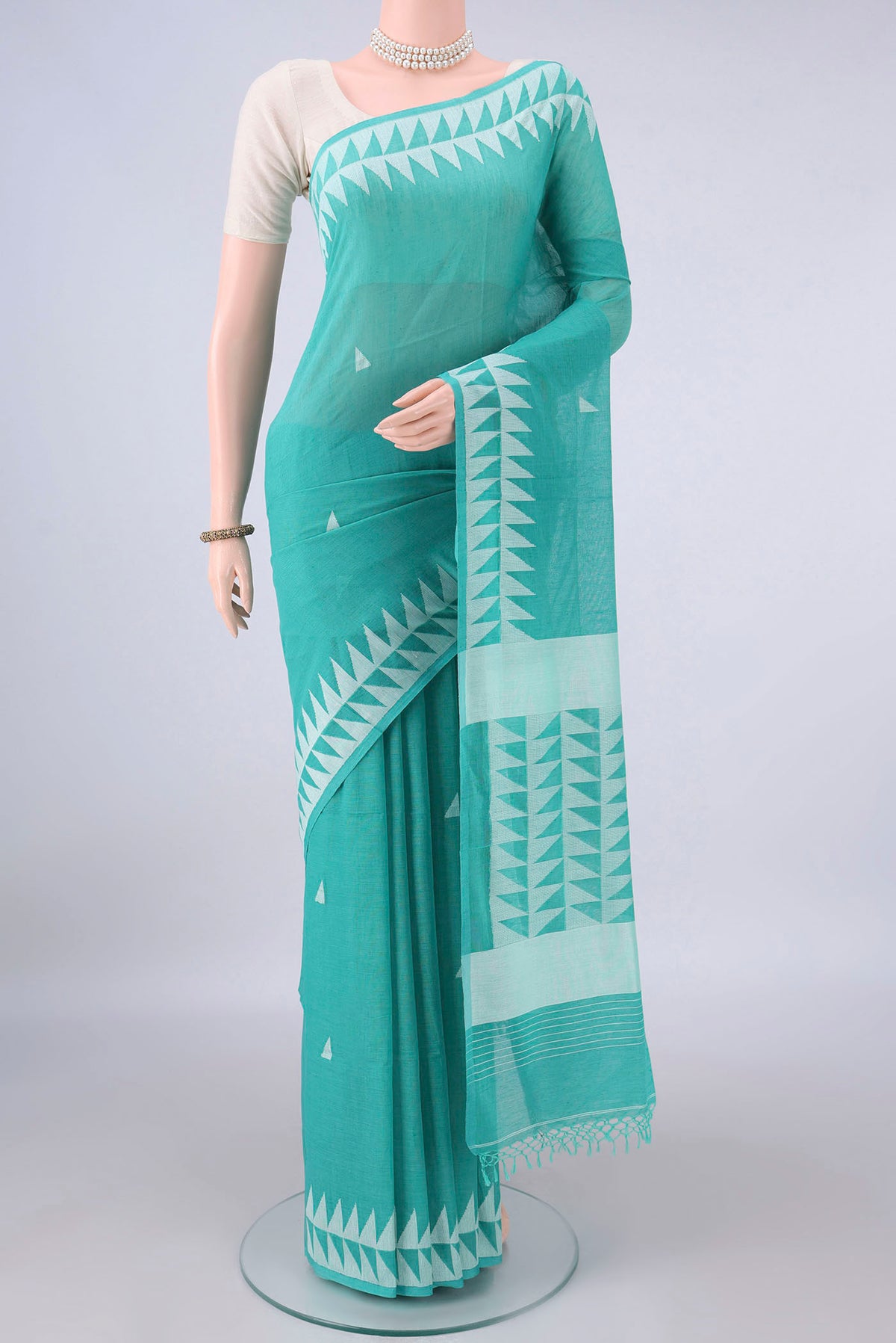 Turquoise Bengal Cotton Saree with Thread Butta on the body and Thread Border.  displayed on a mannequin