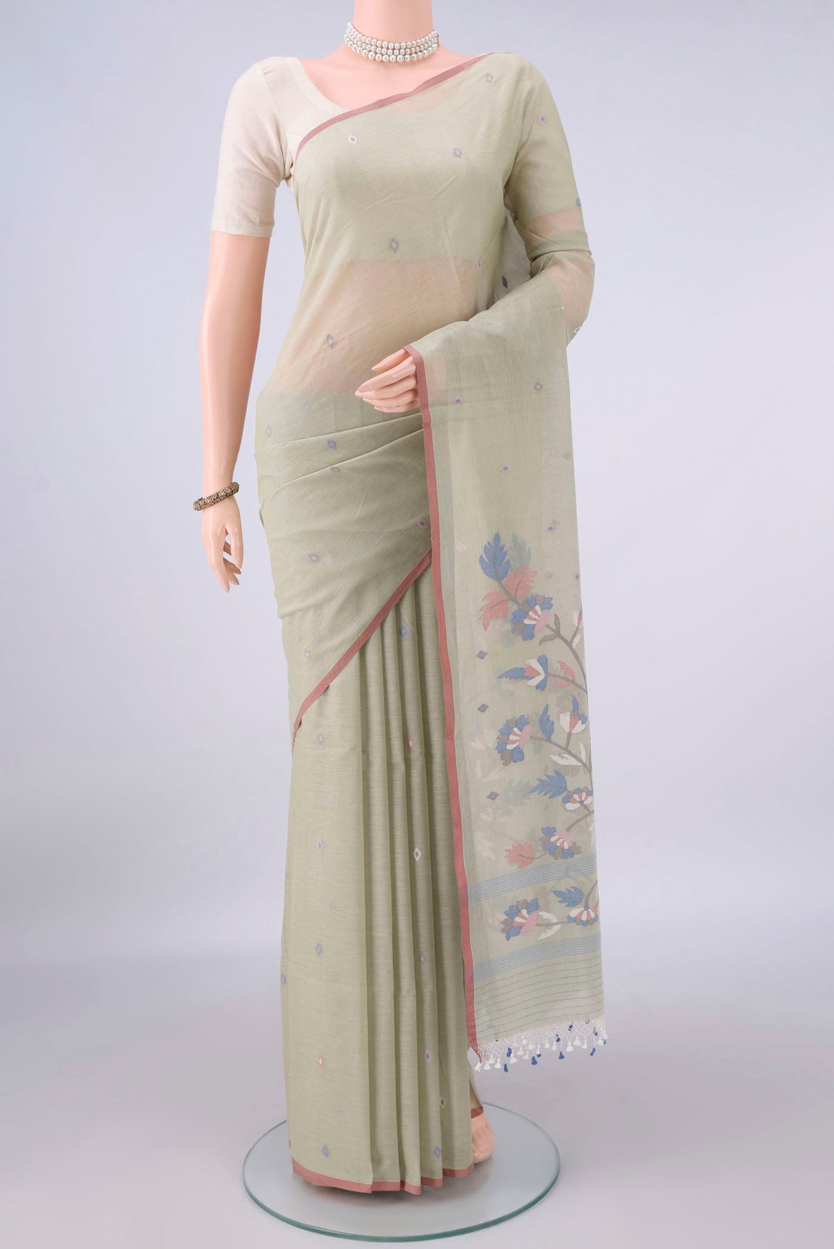 Sage Green Bengal Cotton Saree with Thread Butta on the body and Plain Border.  displayed on a mannequin